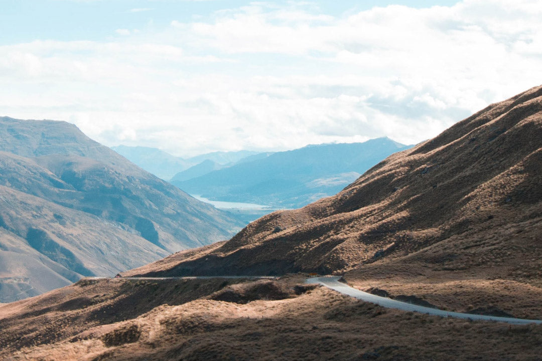 A photo of a road winding through a mountainous landscape