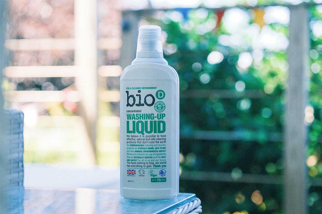 A bottle of Bio-D washing up liquid on the corner of a table 