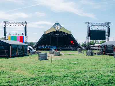 A photo of a pyramid-shaped festival stage being set up