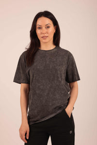 A model with their hand in their pocket, wearing a charcoal coloured textured t-shirt by Hexed Fashion