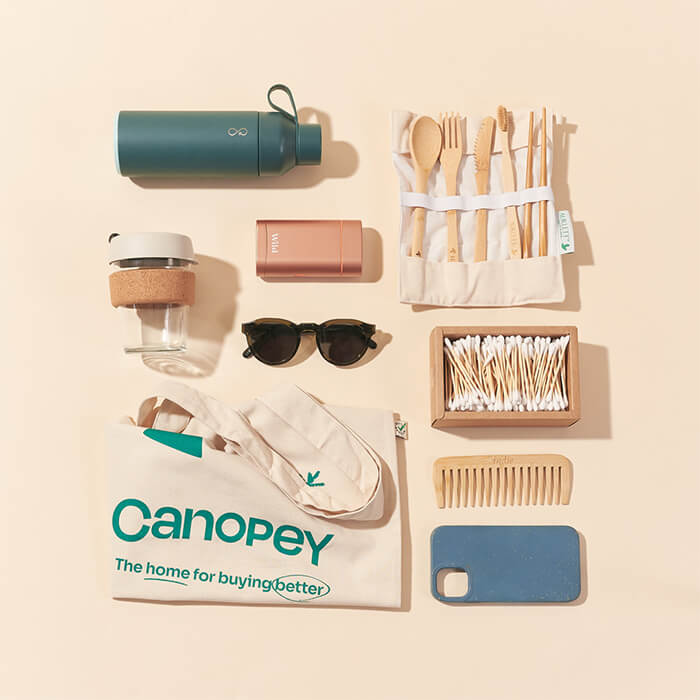 A group of travel products including cutlery, a water bottle and tote bag