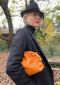 Under Her Eyes Norma Large Clutch, Shoulder & Cross Body Bag in Vintage Orange